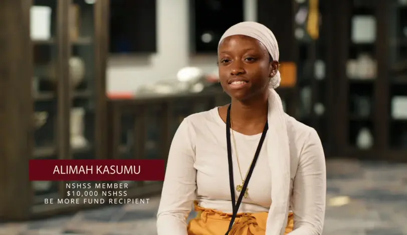 A woman in headscarf being interviewed