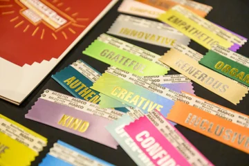 Be More ribbons next to Scholar's Day program