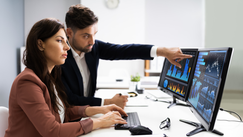 Two colleagues working together analyzing data