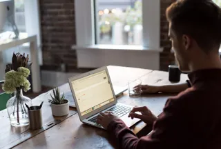 Man staring at laptop on desk