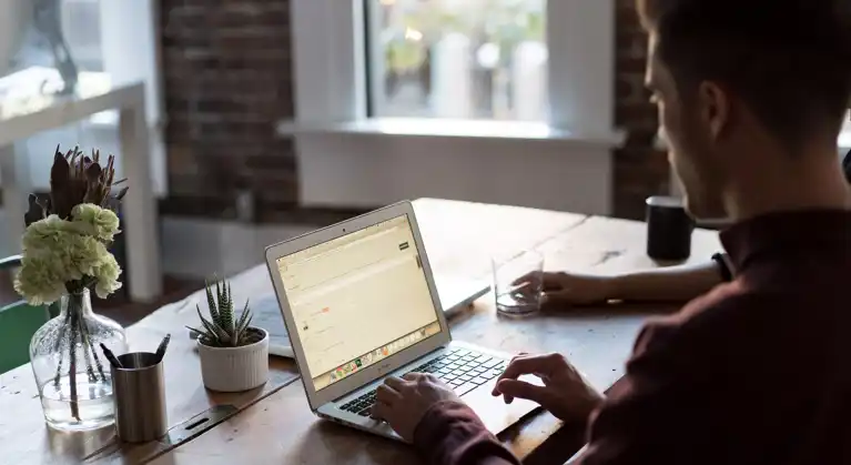 Man staring at laptop on desk