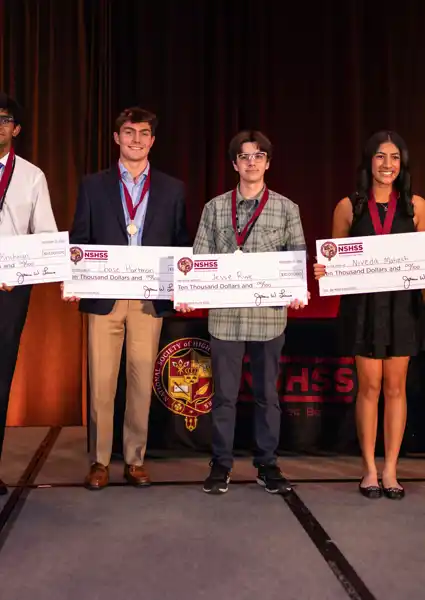 A young group all holding checks