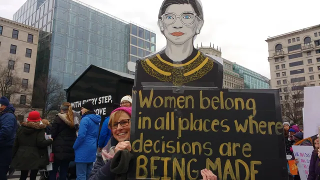 Womanbeingmadeposterduringprotest_2023